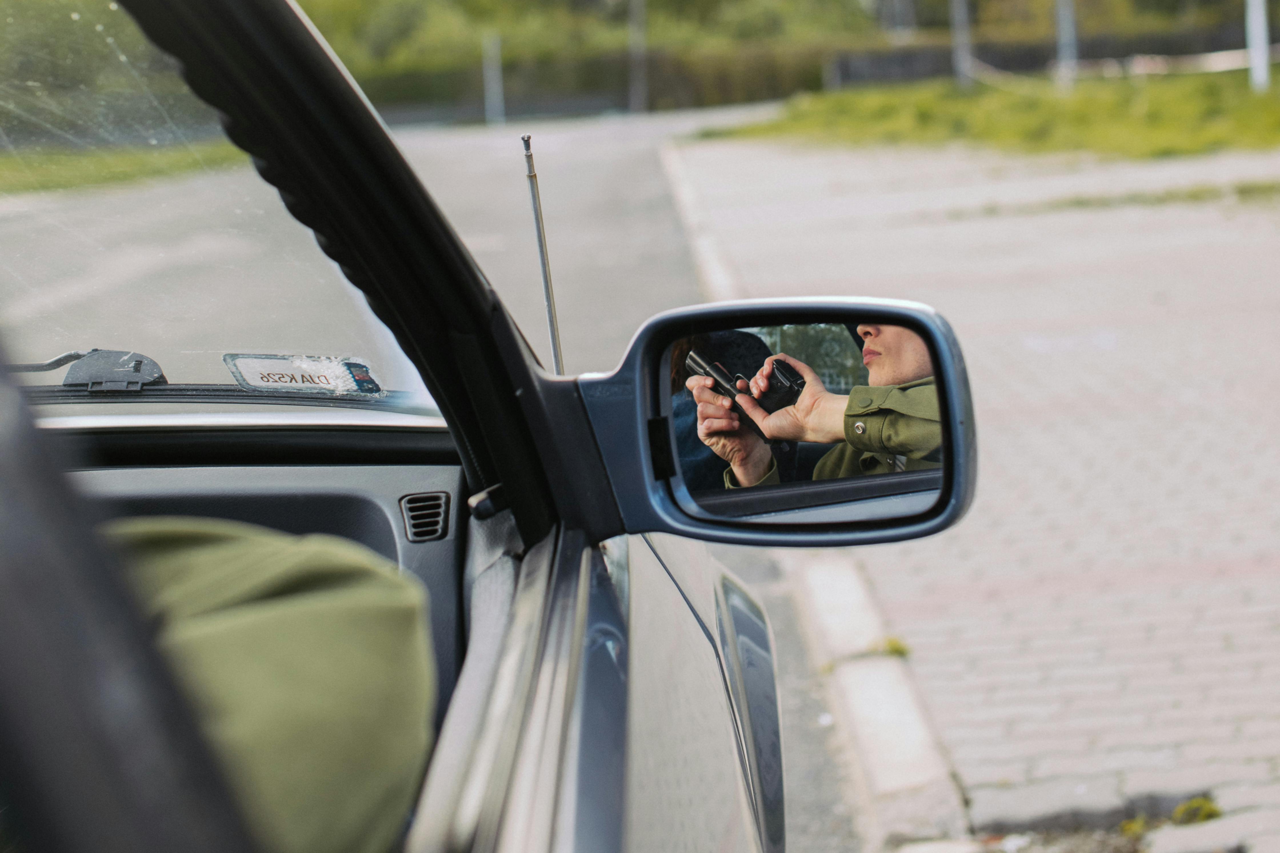 person in green jacket driving car