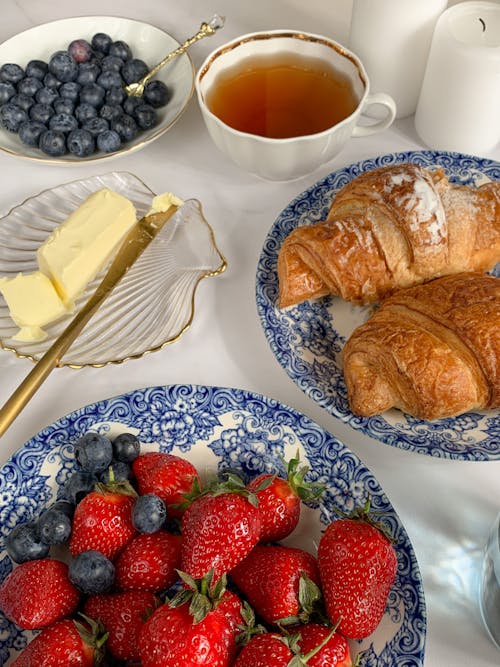 Berries and Croissants Beside a Cup of Tea