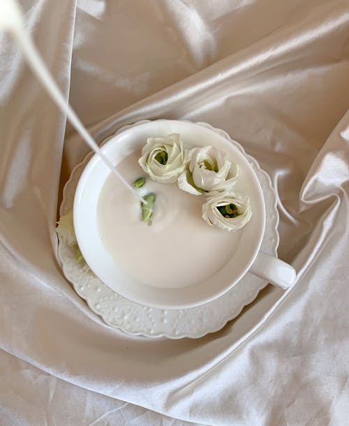 White Flowers in a Ceramic Cup With White Liquid