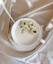 White Ceramic Teacup With Saucer on White Textile