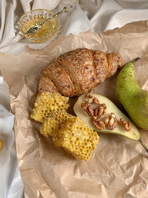 Free Croissant and Honeycomb on a Brown Paper Stock Photo