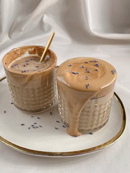 Indulge in a creamy dalgona coffee adorned with delicate lavender petals, perfect for a stylish coffee break.