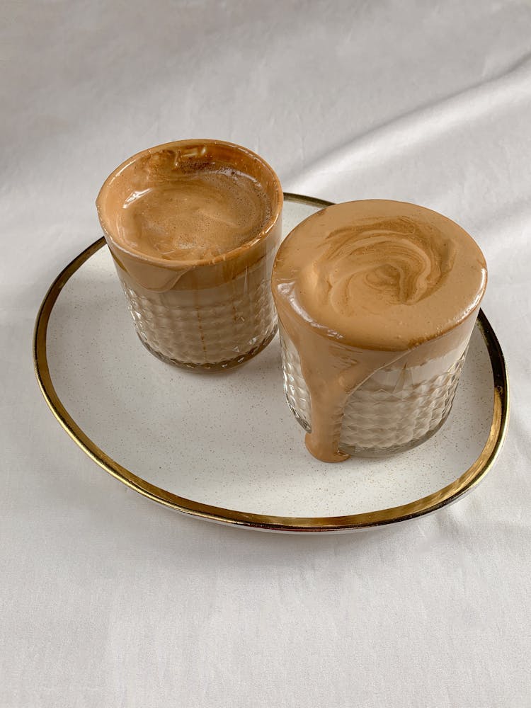 Overflowing Dalgona Coffee In Clear Glass Cups 