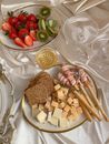Cheese Platter with Breads and Platter of Fruits on Table