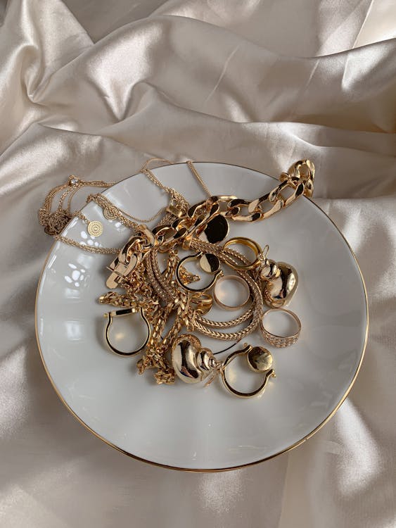 Golden Accessories on White Saucer · Free Stock Photo