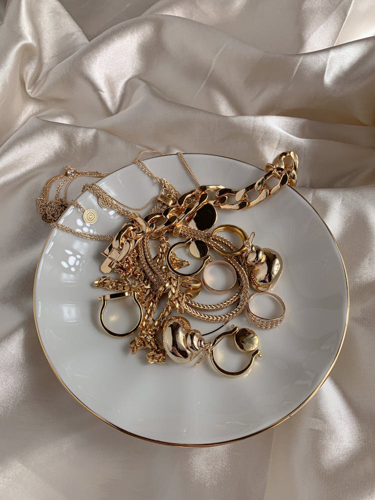 Golden Accessories On White Saucer