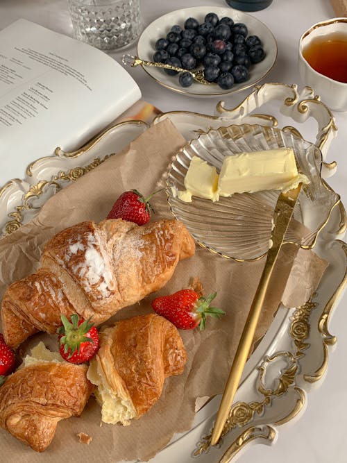 Free Croissants with Strawberries Beside Butter and Blueberries Stock Photo