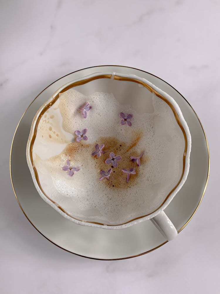 Lilac Flowers In White Cup On White Saucer