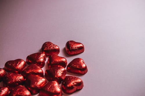 Red Heart Shaped Candies on Pink Background