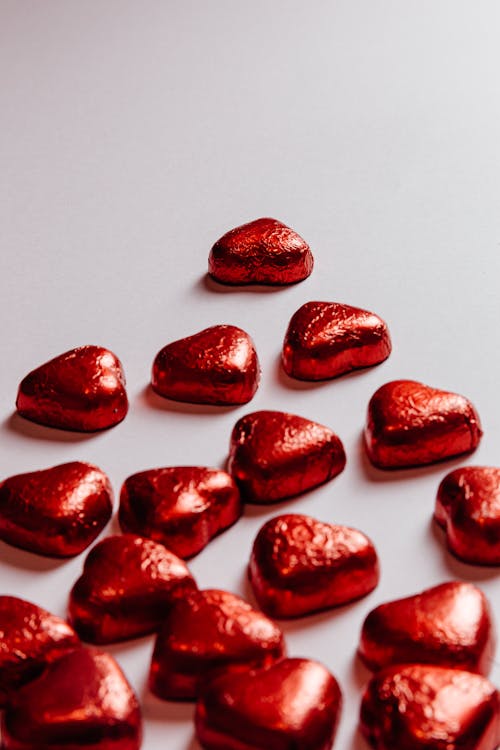 Red Heart Shaped Candies on Pink Background