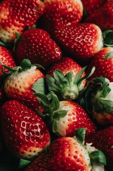 Vibrant ripe strawberries with leaves, showcasing freshness and natural sweetness.