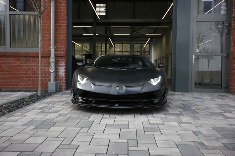Mask Of A Black Porsche Driving Out Of A Garage