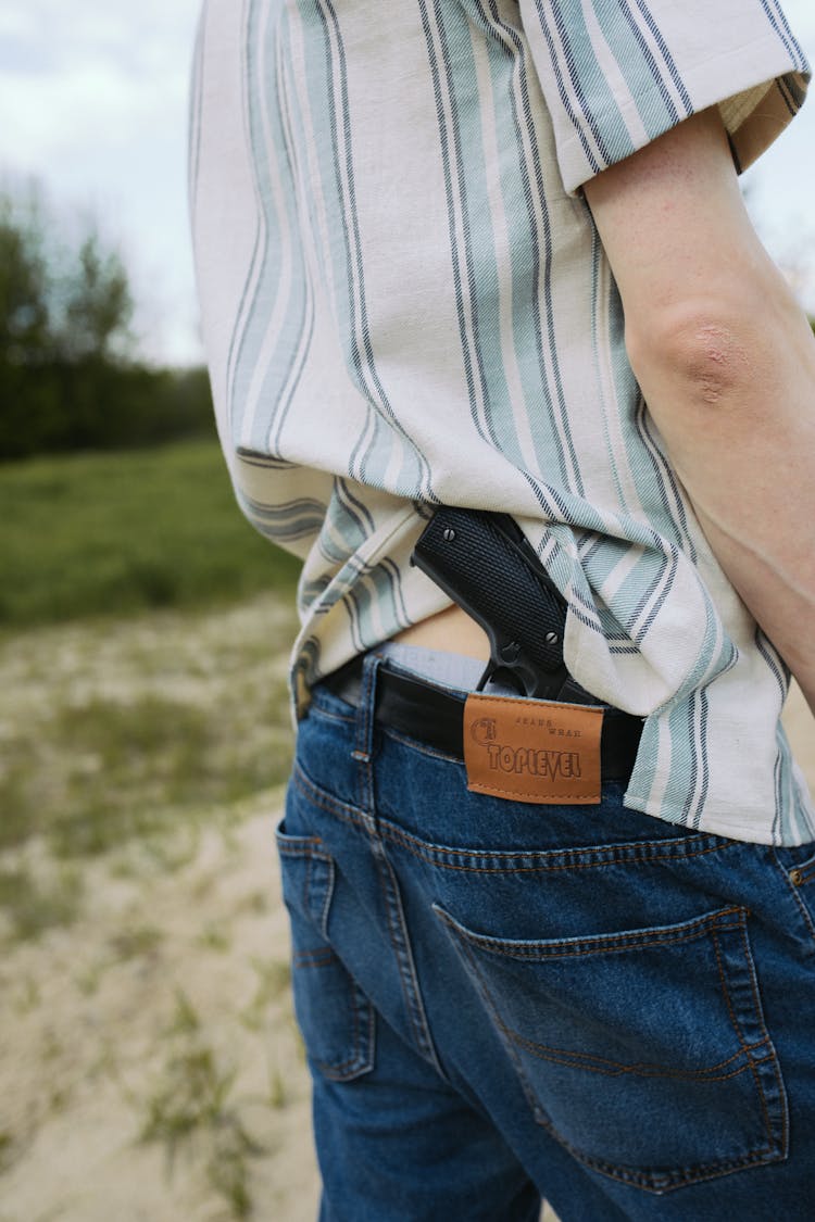 Person In Blue Denim Jeans And White Shirt