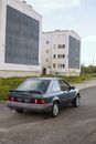 Black Sedan Parked Beside White Concrete Building