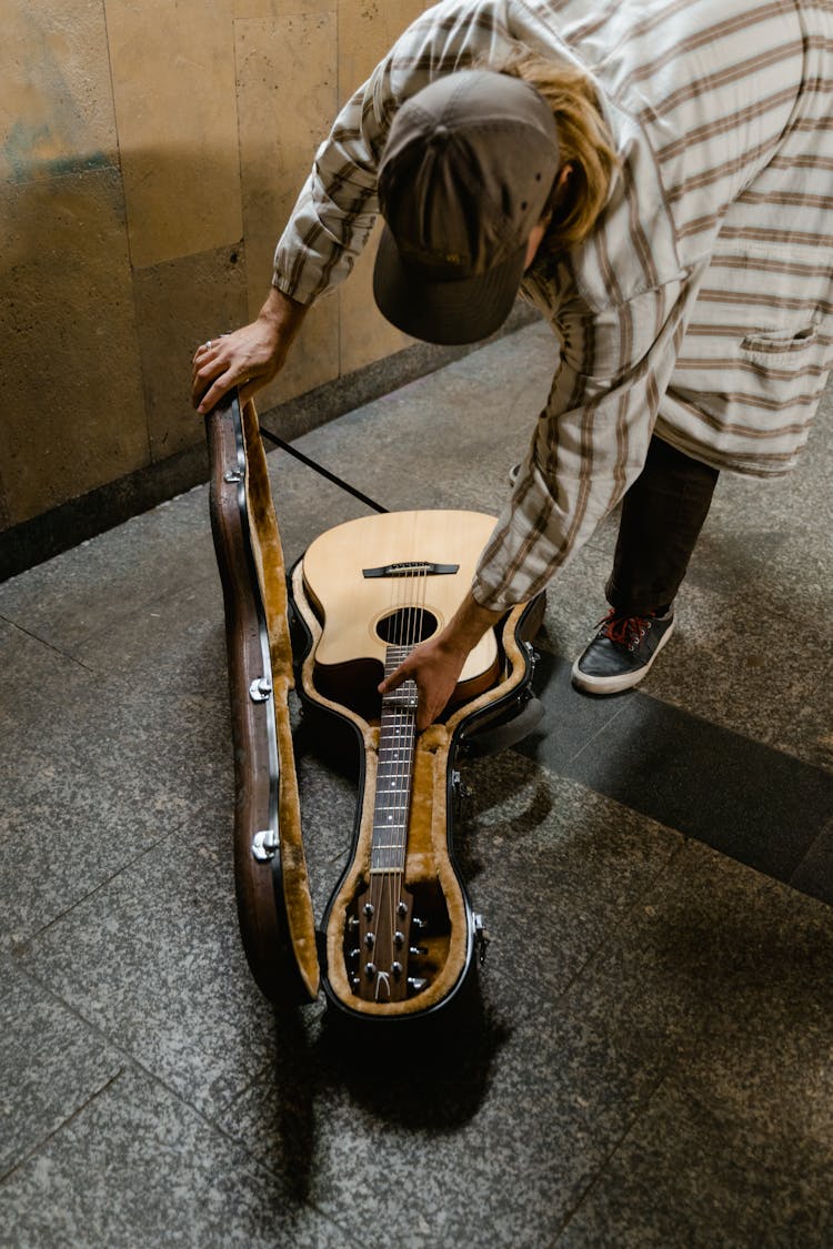 Man Opening His Guitar Case