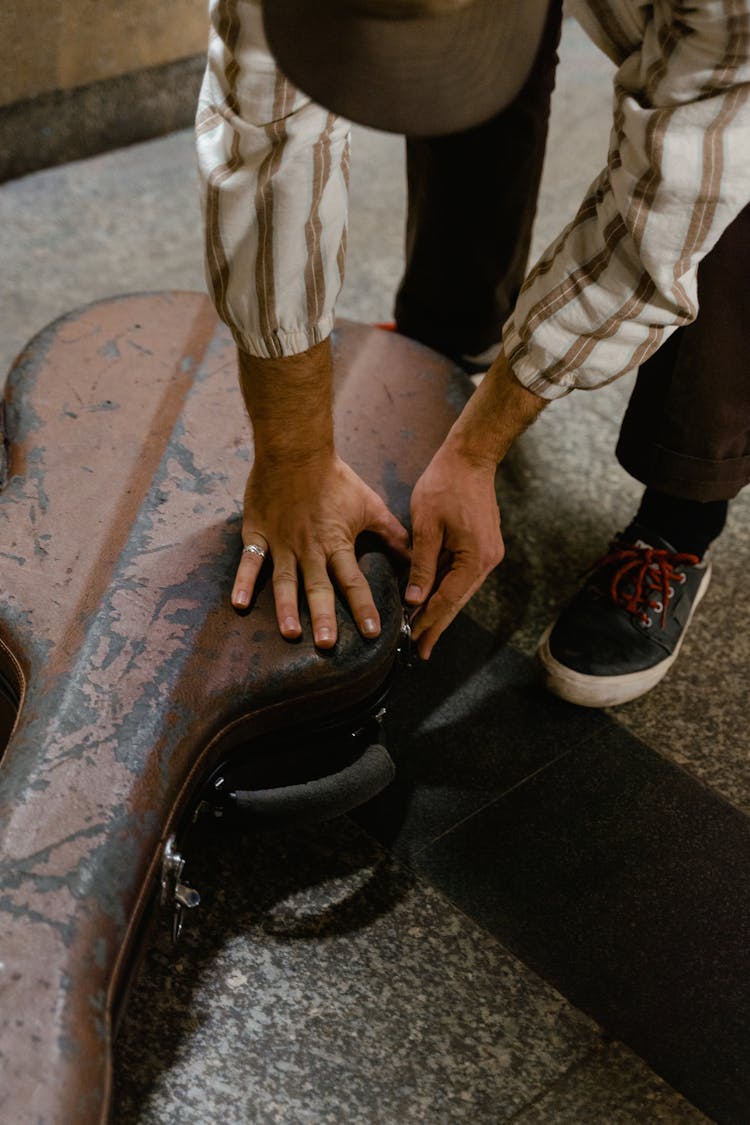 Man Closing His Guitar Case