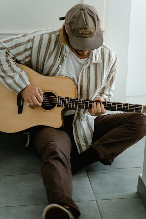 Free Man in White and Brown Stripe Dress Shirt Playing Brown Acoustic Guitar Stock Photo