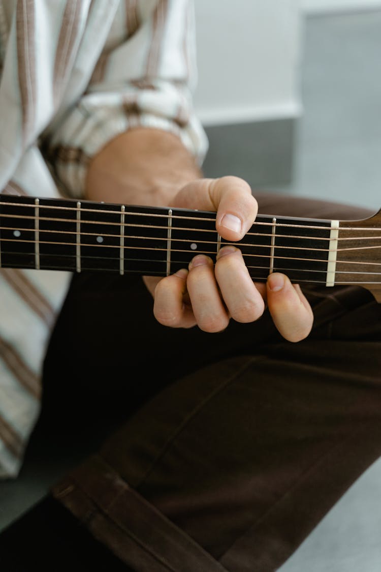 Person Playing Acoustic Guitar