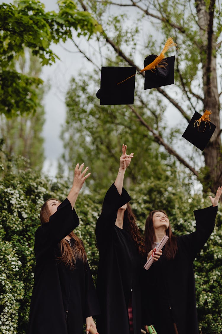 Women Throwing Their Graduation Hats