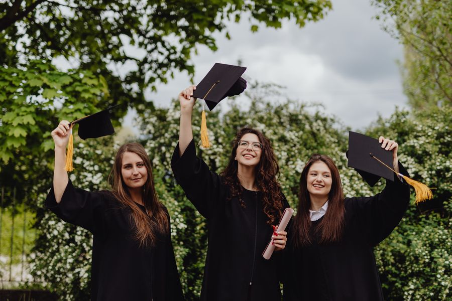 Graduates celebrating together at an education event