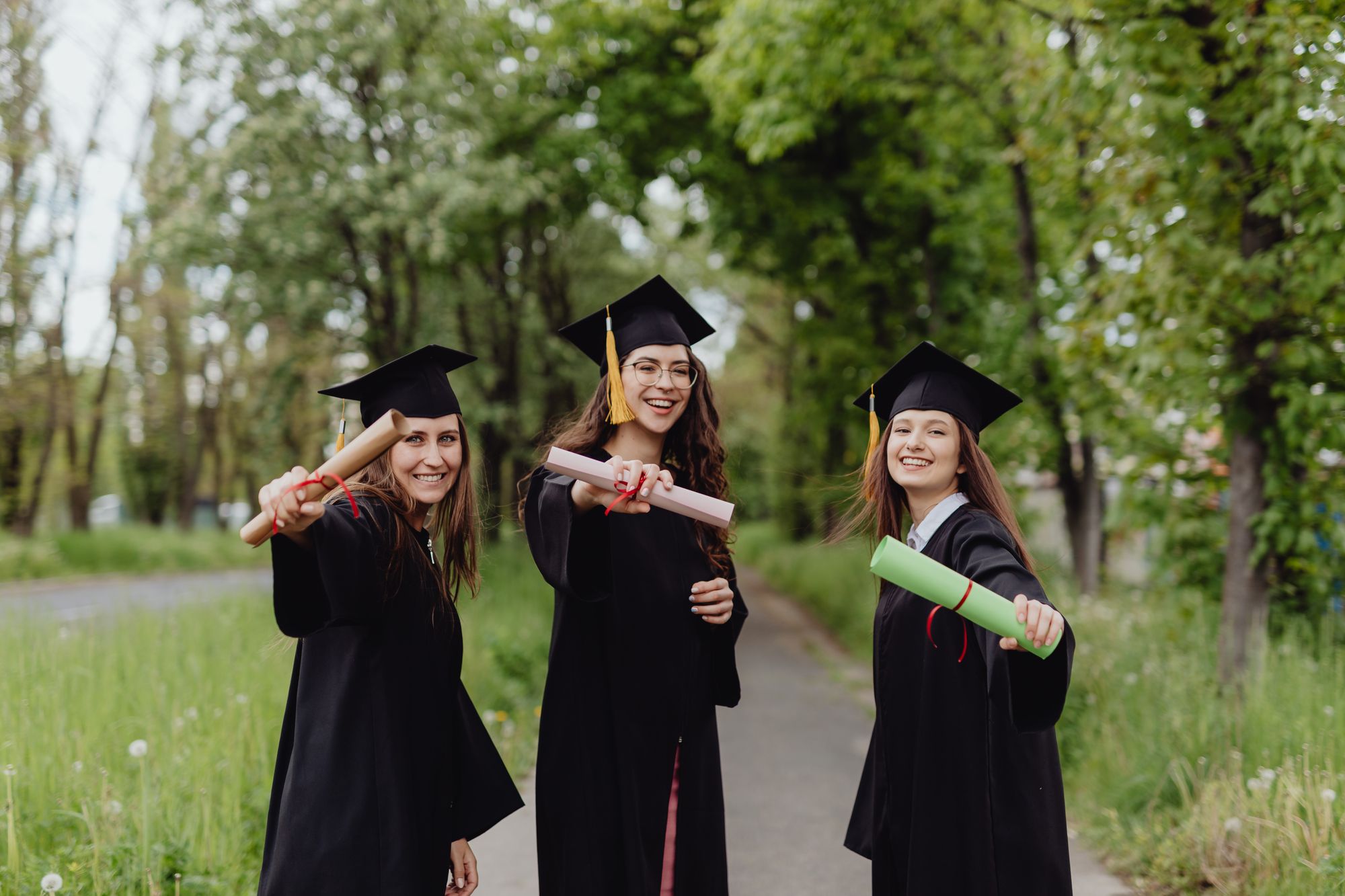 Aurelia Crest sisters celebrating graduation in a park