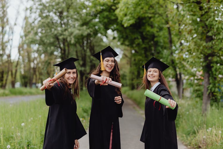 Young Graduates Holding Their Diplomas