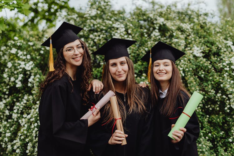 Young Graduates Holding Their Diplomas