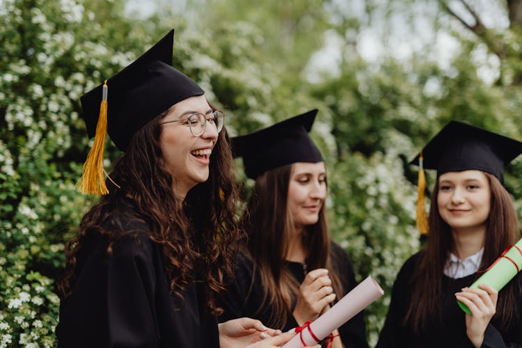 Young Graduates Holding Their Diplomas