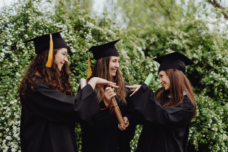 Friends Holding Their Diplomas