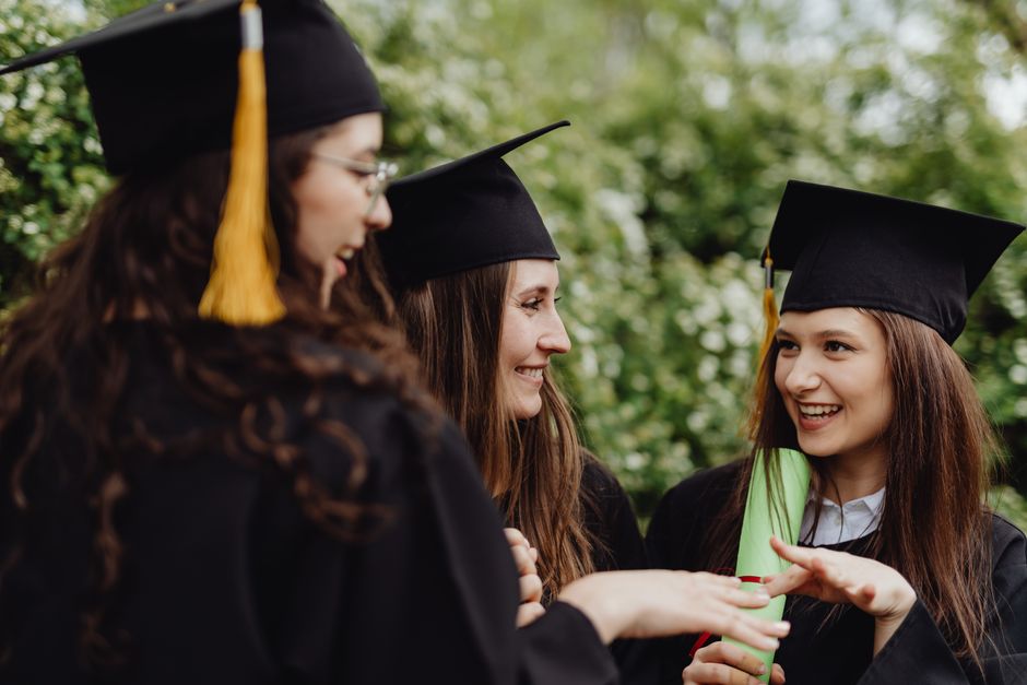 Young graduates celebrating — representing the long-term benefit of converting 529 funds to Roth IRA for expat children