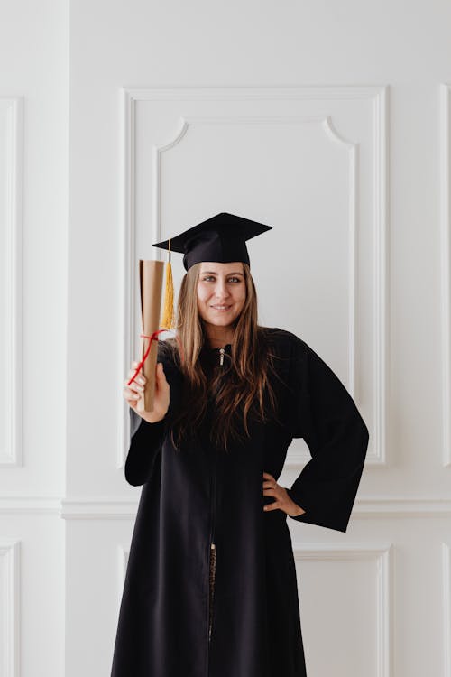 Woman Wearing Graduation Cap Holding a Diploma