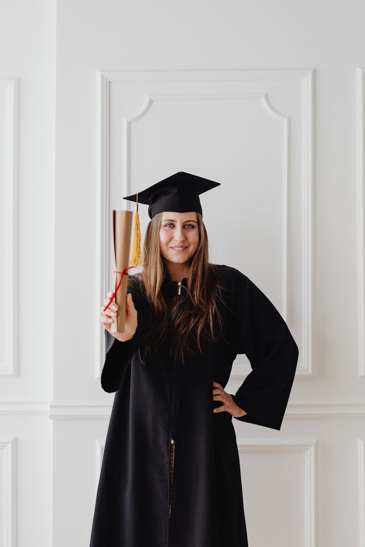 Woman Wearing Graduation Cap Holding A Diploma