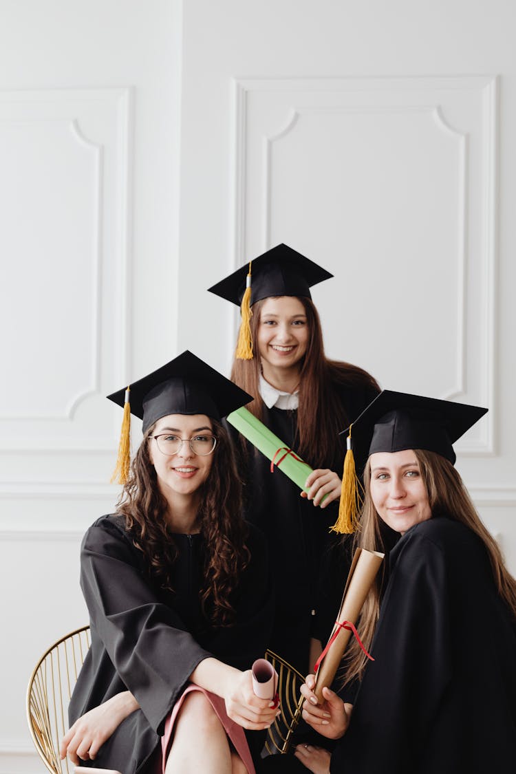 Women In Their Academic Dress And Graduate Caps