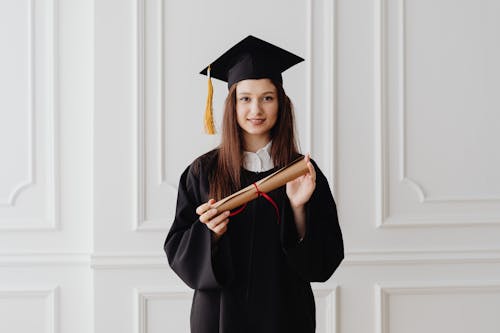 Free A Woman Holding a Diploma Stock Photo