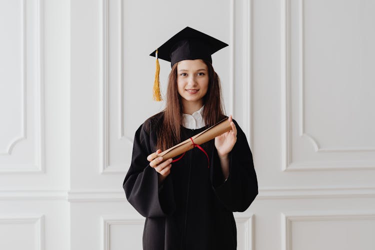 A Woman Holding A Diploma