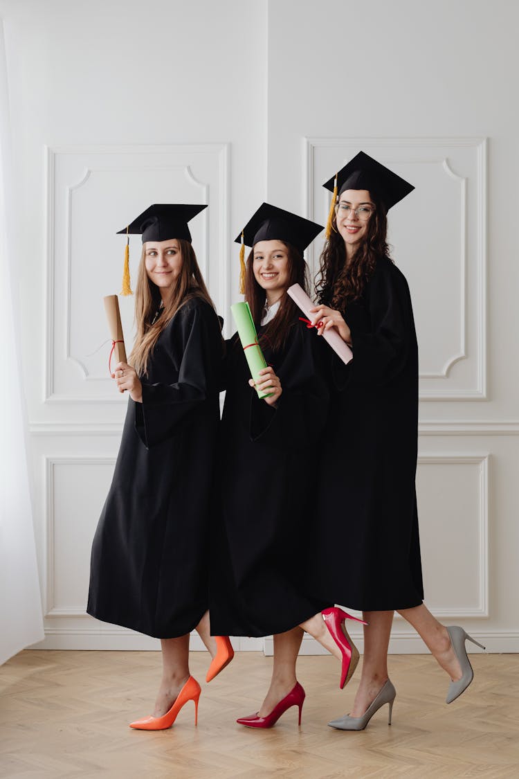 Young Graduates Holding Their Diplomas