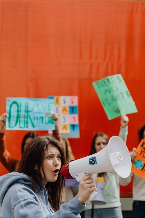 A Woman Protesting while Holding a Megaphone