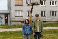 Man in Blue Dress Shirt Standing Beside Woman in Blue Zip Up Jacket