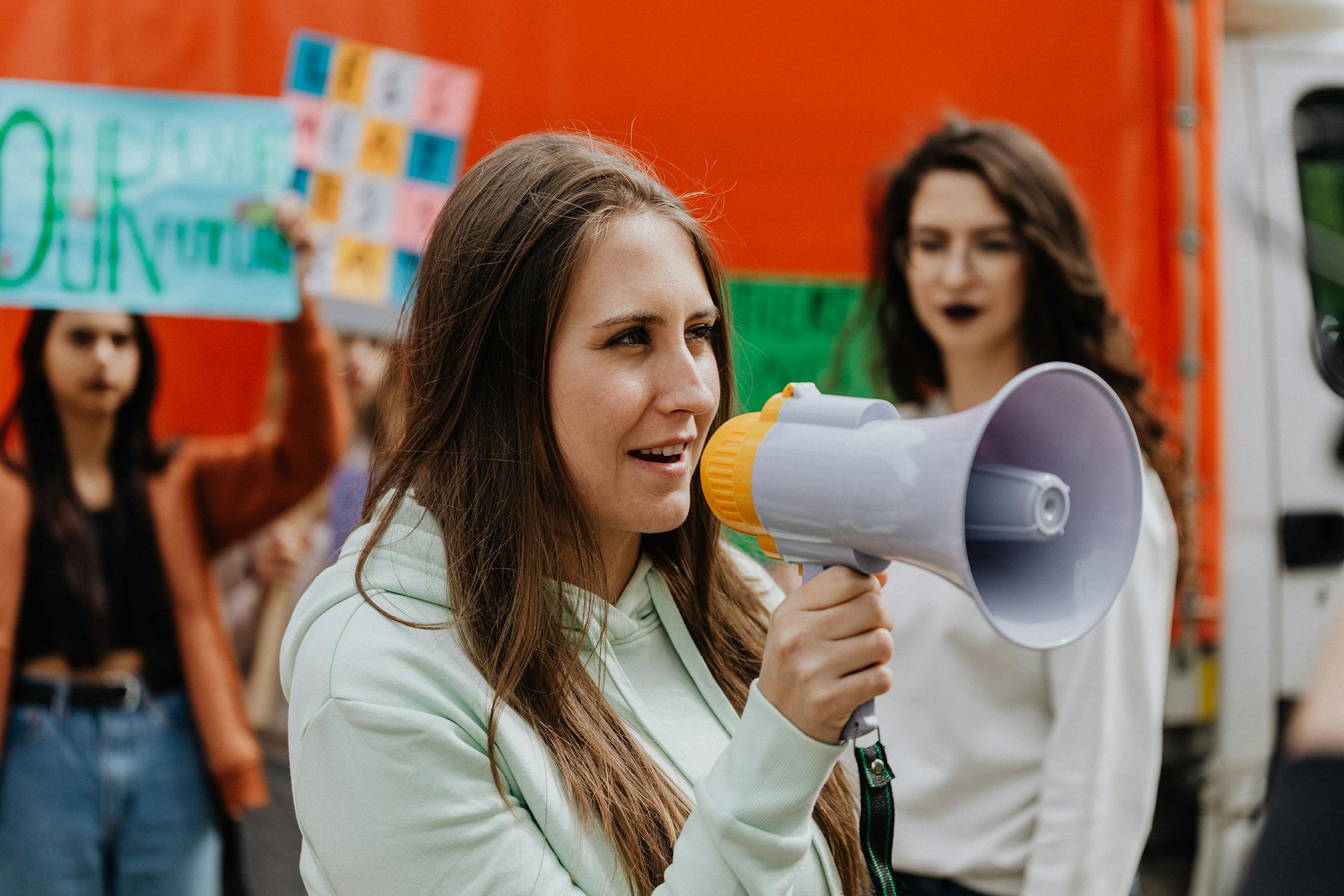 A Woman Holding a Megaphone- communities need to raise awareness for issues like the missing teen girl