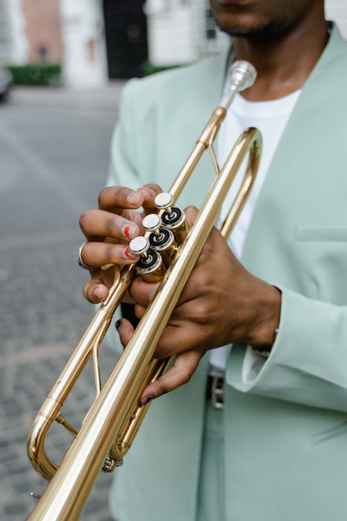 Person Holding Brass Trumpet