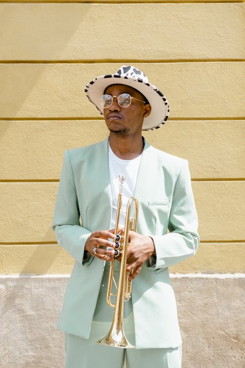 Man in Suit Holding a Trumpet