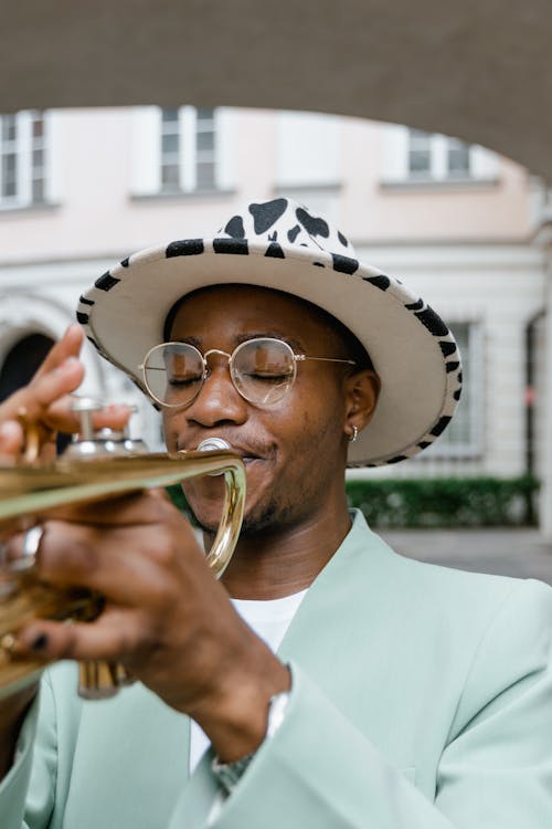 Man in White and Black Hat Playing Trumpet