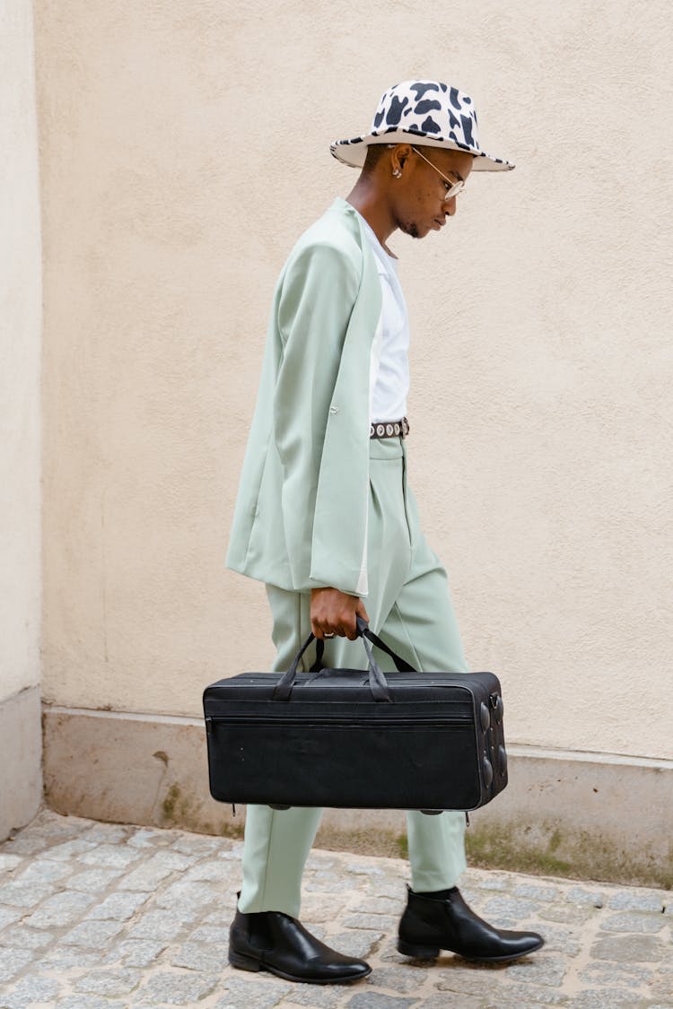 Man Carrying A Black Bag