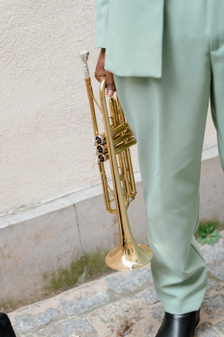 Person Holding Brass Trumpet