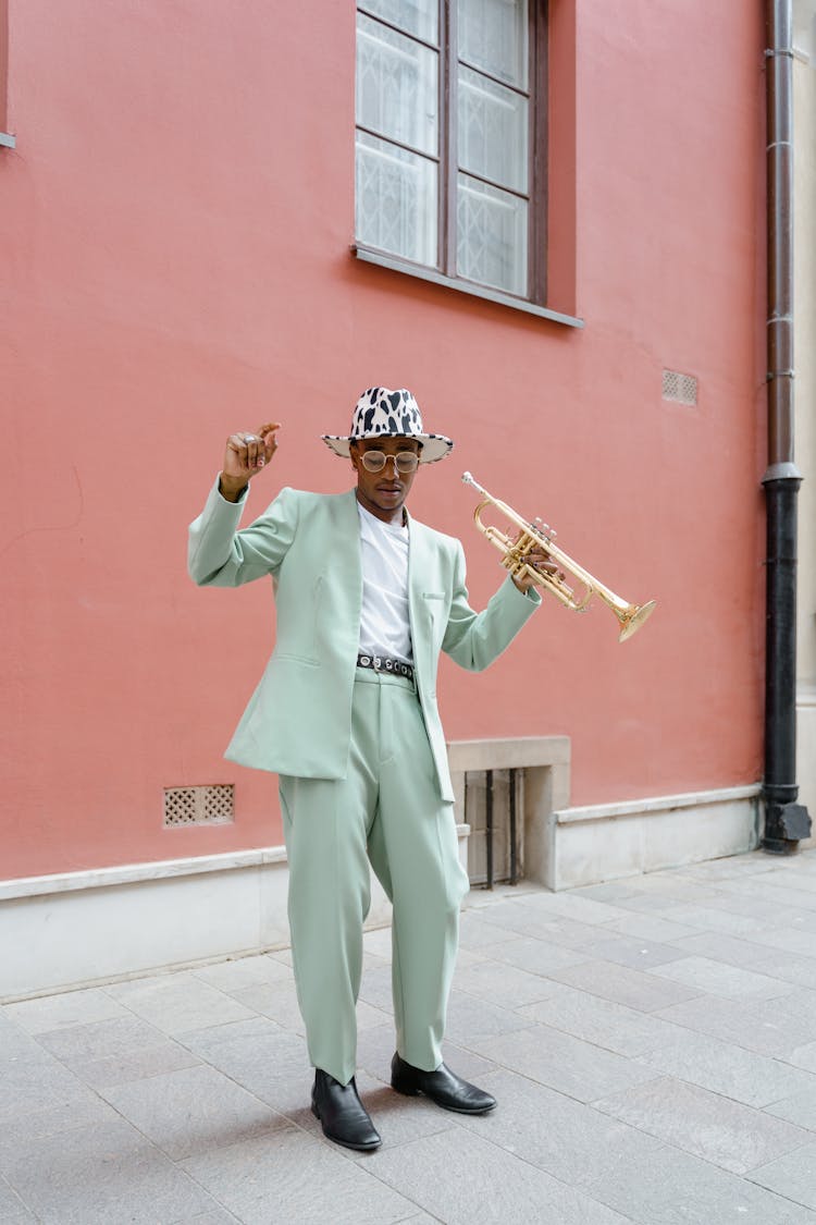 Man In Suit Dancing And Holding A Trumpet