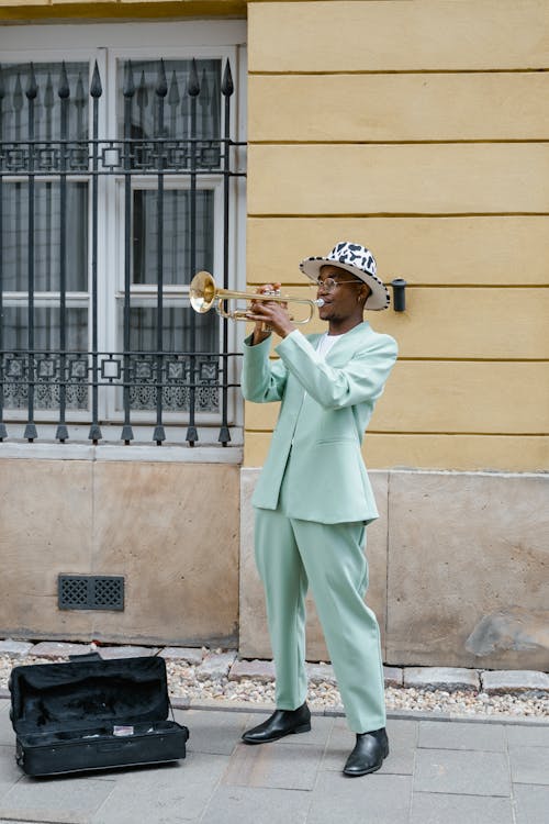 Man in Green Suit Playing Trumpet