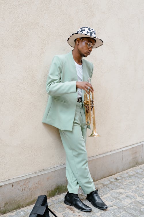 Man in Teal Suit Holding a Trumpet