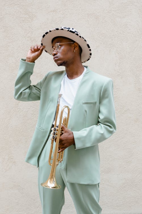 Man in Teal Suit Holding a Trumpet