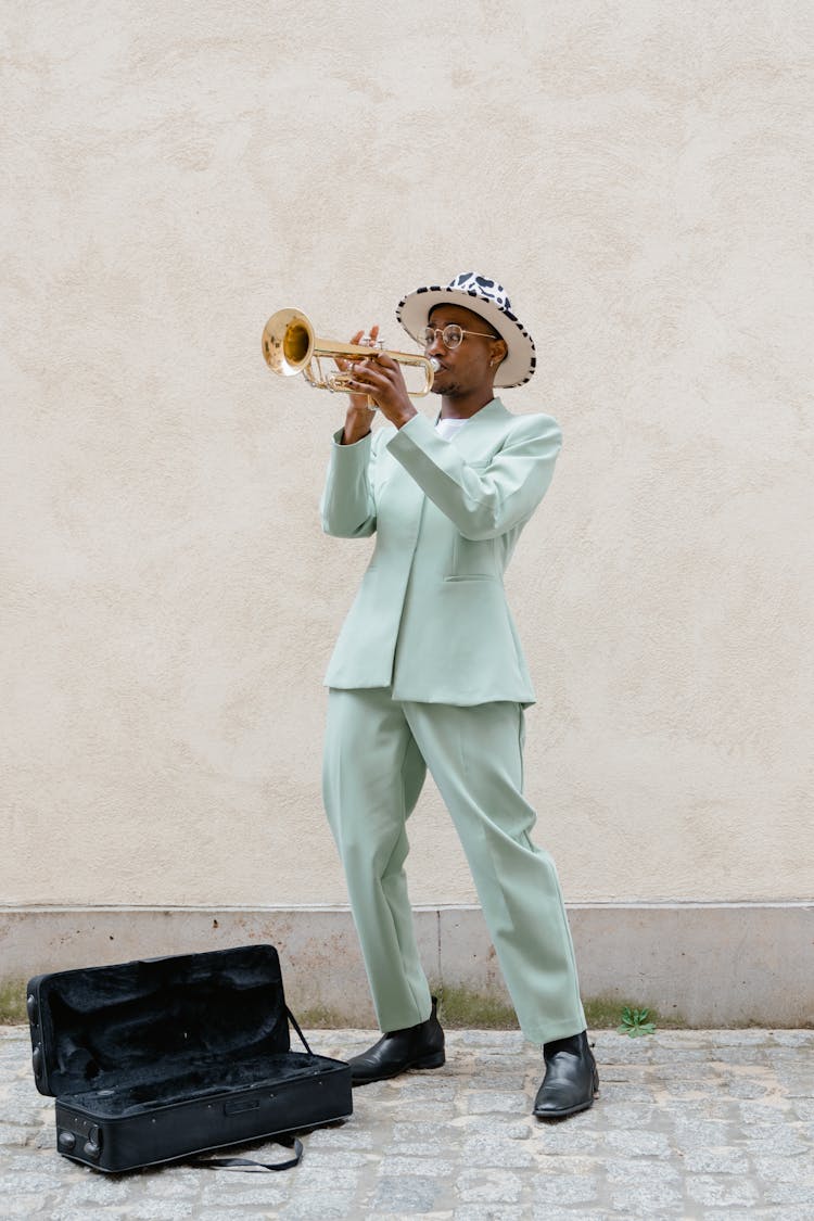 Man In Teal Suit Playing Trumpet