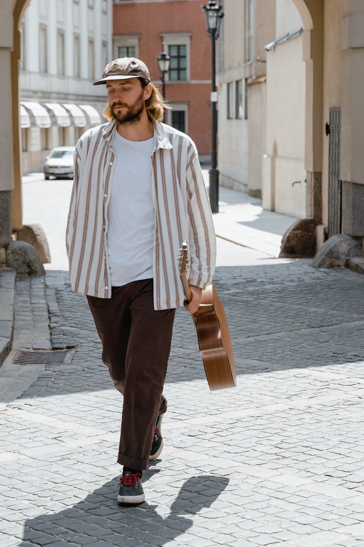 Man Carrying His Guitar